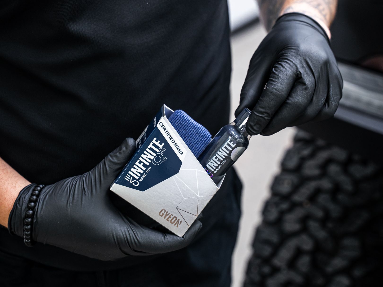 Technician at Denver Auto Shield holding a GYEON ceramic coating kit before application